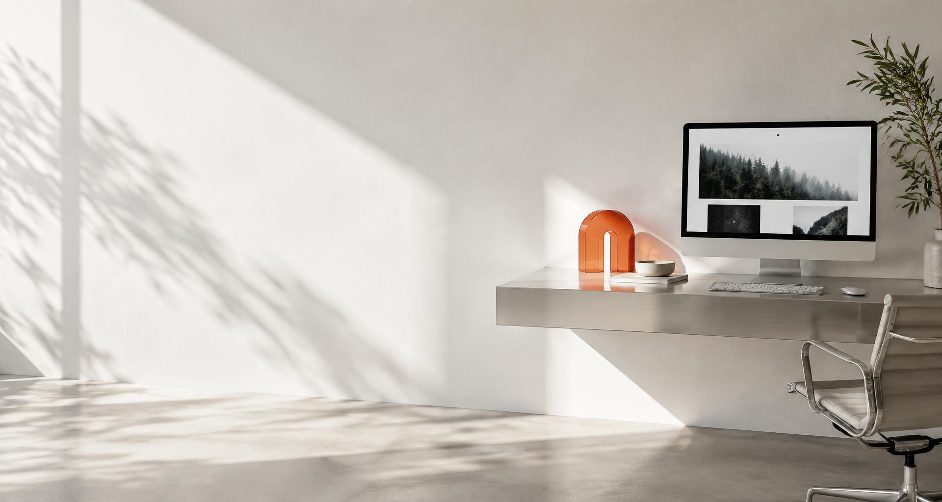 A thoughtfully designed creative workspace with a website on screen